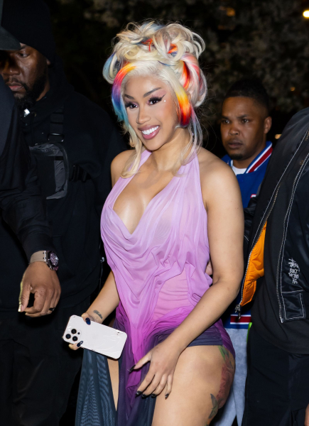 Cardi B wearing a purple halter dress and rainbow and blonde updo