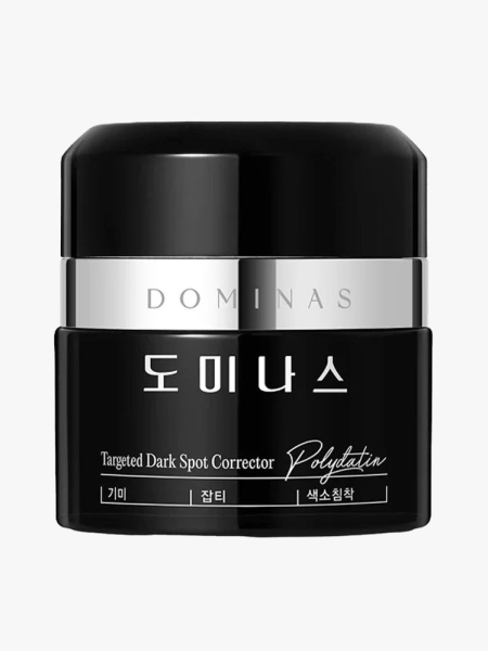 Dominas Targeted Dark Spot Corrector black and silver jar on light gray background